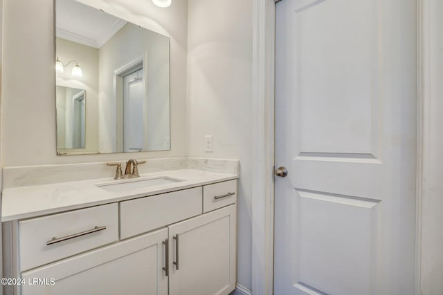 bathroom featuring crown molding and vanity