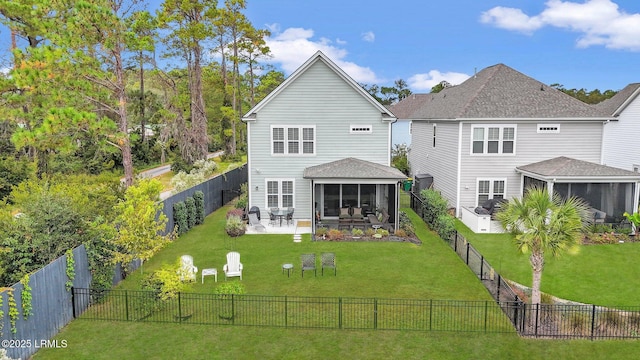 back of property with a sunroom, a fenced backyard, and a lawn