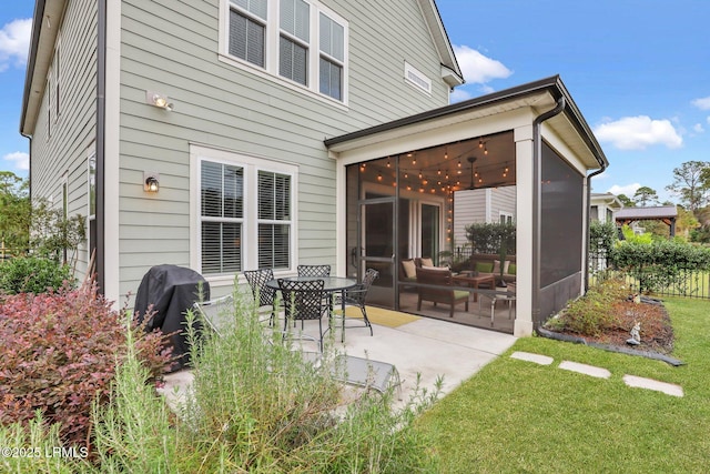 exterior space featuring a sunroom and a grill