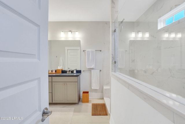 bathroom with tile patterned flooring, vanity, and a walk in shower