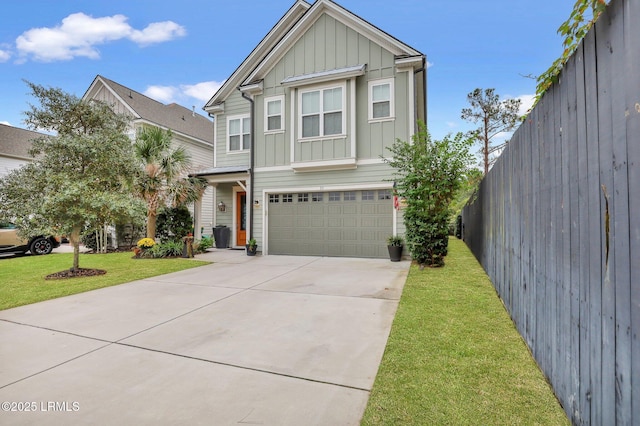 view of front facade with an attached garage, fence, concrete driveway, a front lawn, and board and batten siding