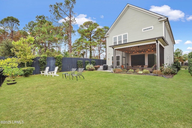 rear view of house featuring a yard, a patio area, and a fenced backyard