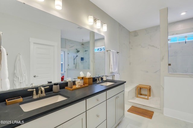 bathroom with plenty of natural light, walk in shower, and a sink