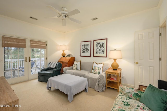 carpeted living room with french doors, ceiling fan, and crown molding