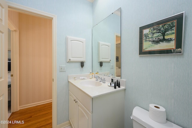 bathroom with vanity, hardwood / wood-style floors, and toilet