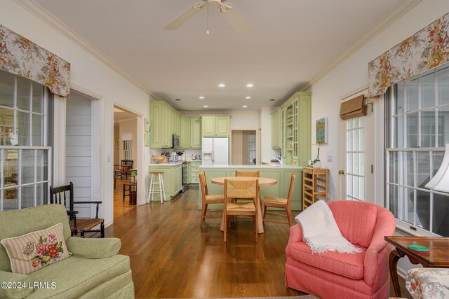 living room with crown molding, ceiling fan, and dark hardwood / wood-style floors