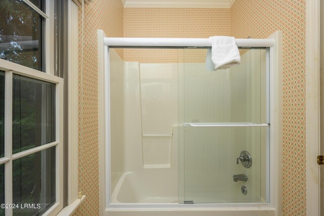 bathroom featuring enclosed tub / shower combo and ornamental molding