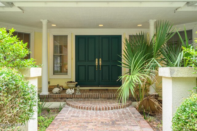 view of exterior entry with a porch