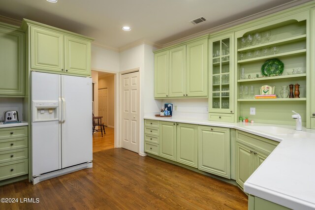 kitchen with crown molding, dark hardwood / wood-style flooring, white refrigerator with ice dispenser, and sink