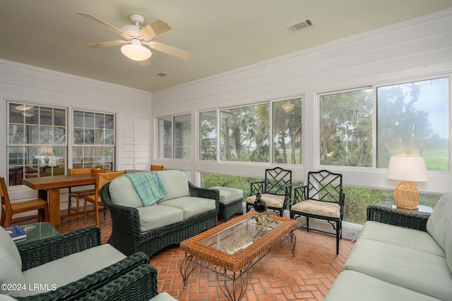 sunroom / solarium featuring ceiling fan