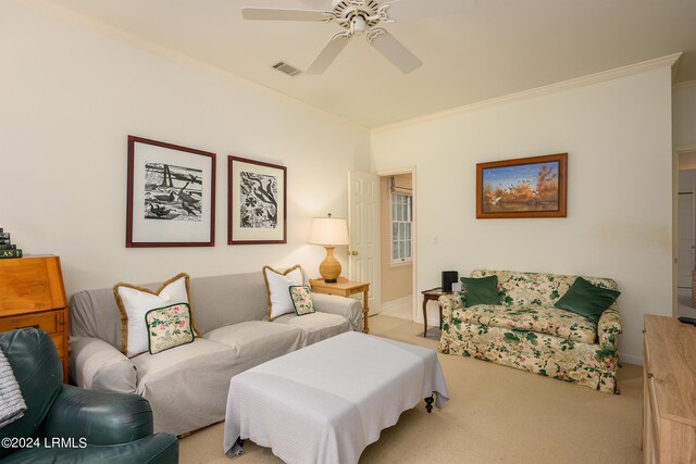 carpeted living room featuring ornamental molding and ceiling fan