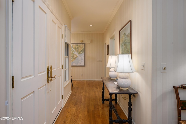 corridor featuring hardwood / wood-style flooring and ornamental molding