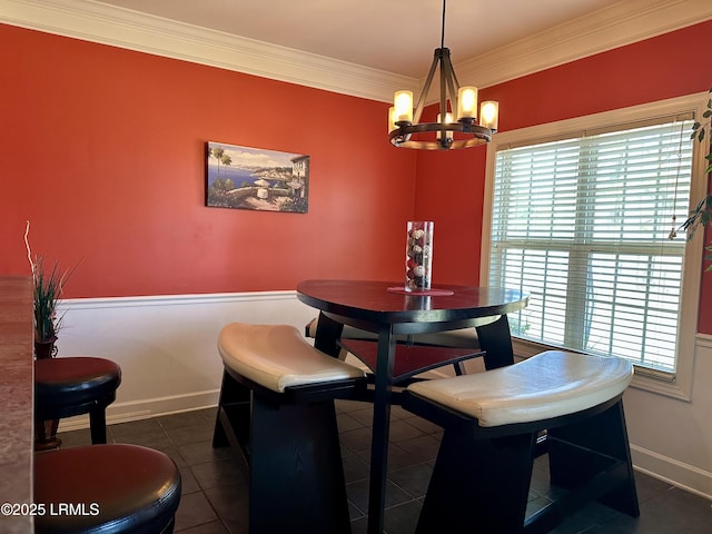 dining room with tile patterned floors, baseboards, a chandelier, and ornamental molding