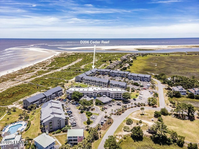 bird's eye view featuring a water view and a beach view