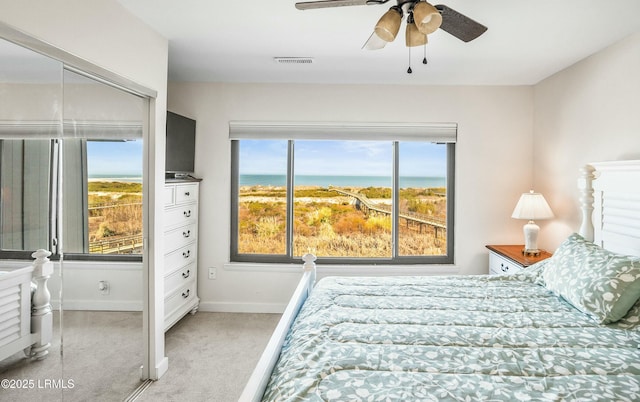 bedroom featuring light carpet and ceiling fan