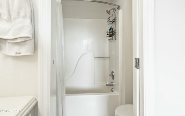 bathroom featuring bathing tub / shower combination and toilet