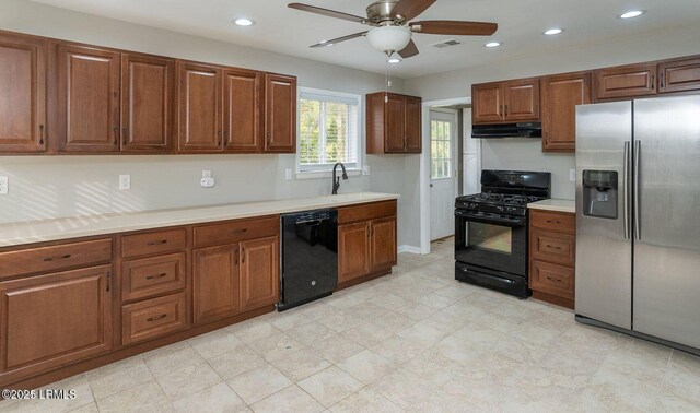 1717 Drayton Dr, Port Royal, SC 29935 - kitchen featuring under cabinet range hood, light countertops, a sink, black appliances, and ceiling fan