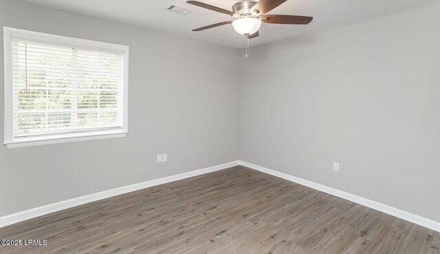 1717 Drayton Dr, Port Royal, SC 29935 - empty room featuring wood finished floors, visible vents, baseboards, and ceiling fan