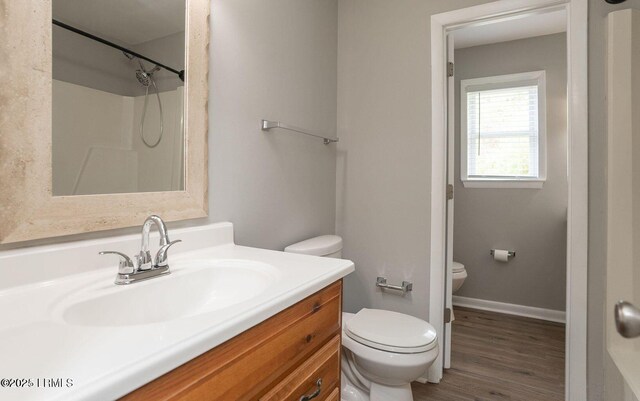 1717 Drayton Dr, Port Royal, SC 29935 - bathroom with baseboards, wood finished floors, toilet, and vanity