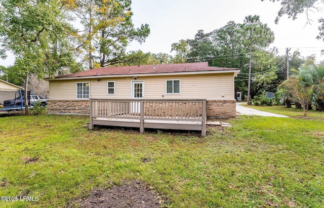 1717 Drayton Dr, Port Royal, SC 29935 - back of house with a lawn, brick siding, and a deck