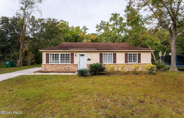 1717 Drayton Dr, Port Royal, SC 29935 - view of front of home with brick siding, a trampoline, and a front lawn