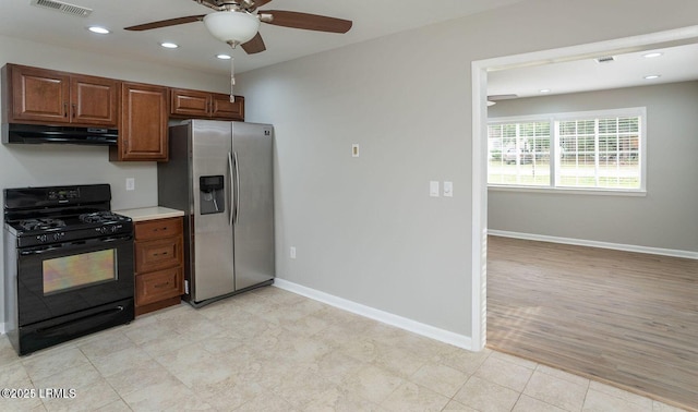 1717 Drayton Dr, Port Royal, SC 29935 - kitchen featuring a ceiling fan, stainless steel fridge with ice dispenser, baseboards, under cabinet range hood, and gas stove