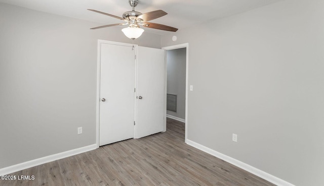 1717 Drayton Dr, Port Royal, SC 29935 - unfurnished bedroom with baseboards, a ceiling fan, wood finished floors, and visible vents