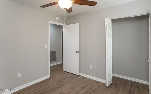 1717 Drayton Dr, Port Royal, SC 29935 - unfurnished bedroom with wood finished floors, visible vents, a ceiling fan, a closet, and baseboards