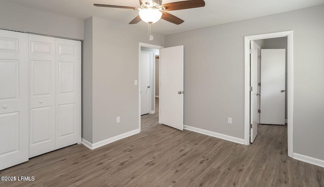 1717 Drayton Dr, Port Royal, SC 29935 - unfurnished bedroom with wood finished floors, a closet, a ceiling fan, and baseboards