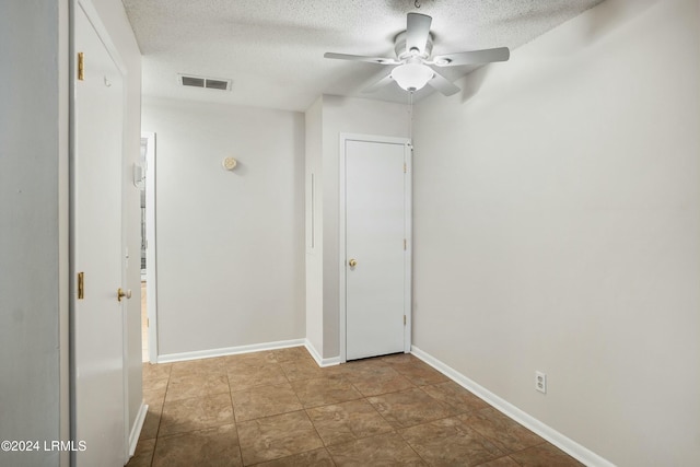 hallway with a textured ceiling