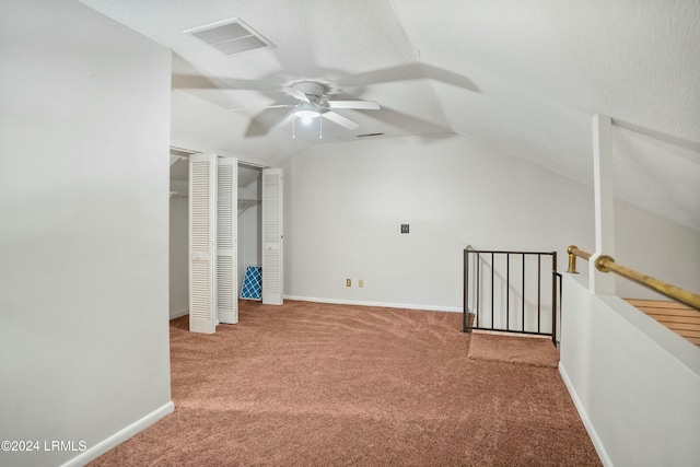 interior space with ceiling fan, carpet floors, and vaulted ceiling