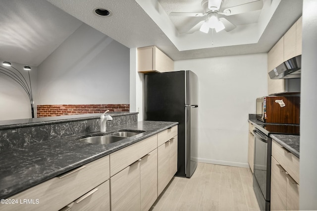 kitchen featuring sink, dark stone countertops, black range with electric stovetop, wall chimney range hood, and light hardwood / wood-style flooring