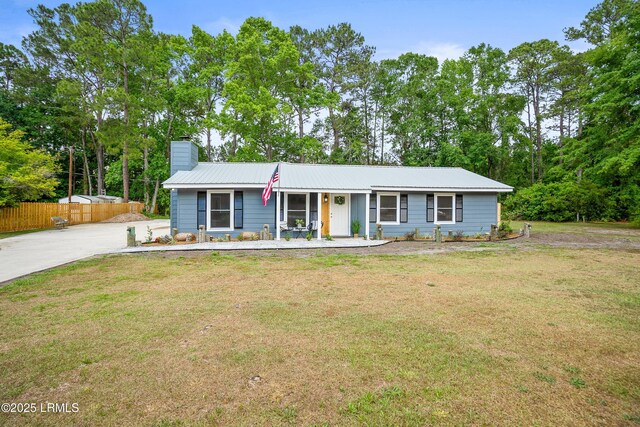 46 Mroz Rd, Beaufort, SC 29906 - view of front of property featuring a chimney, metal roof, a porch, and concrete driveway