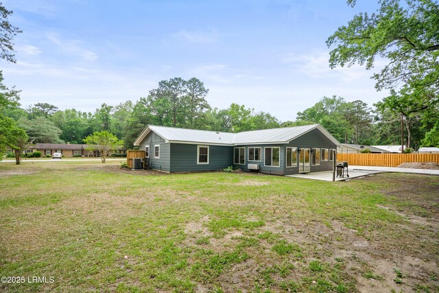 46 Mroz Rd, Beaufort, SC 29906 - rear view of house featuring a patio, metal roof, central AC unit, and view of scattered trees
