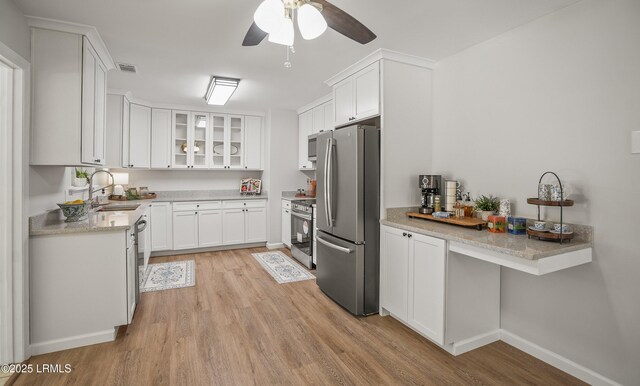 46 Mroz Rd, Beaufort, SC 29906 - kitchen featuring appliances with stainless steel finishes, a sink, light wood-style flooring, ceiling fan, and white cabinetry