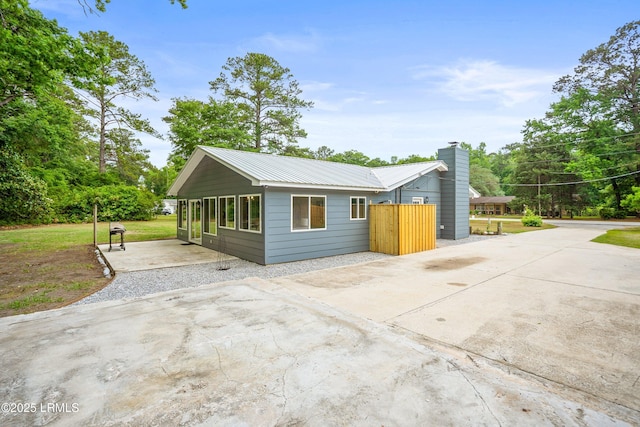 46 Mroz Rd, Beaufort, SC 29906 - view of home's exterior featuring metal roof, a patio area, and fence