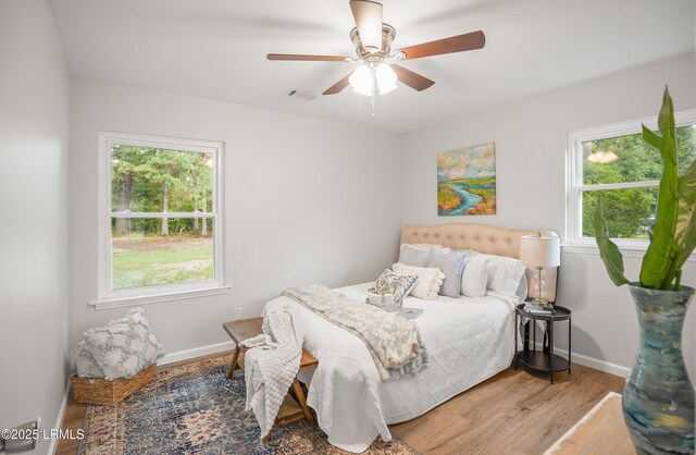 46 Mroz Rd, Beaufort, SC 29906 - bedroom featuring multiple windows, light wood-style floors, baseboards, and ceiling fan