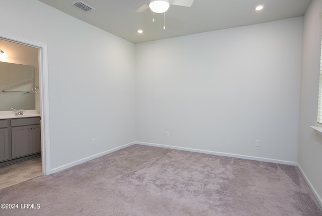 carpeted empty room featuring sink