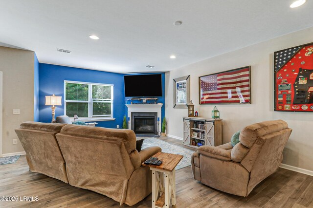 13 Hager Rd, Bluffton, SC 29910 - living area with visible vents, baseboards, recessed lighting, wood finished floors, and a glass covered fireplace