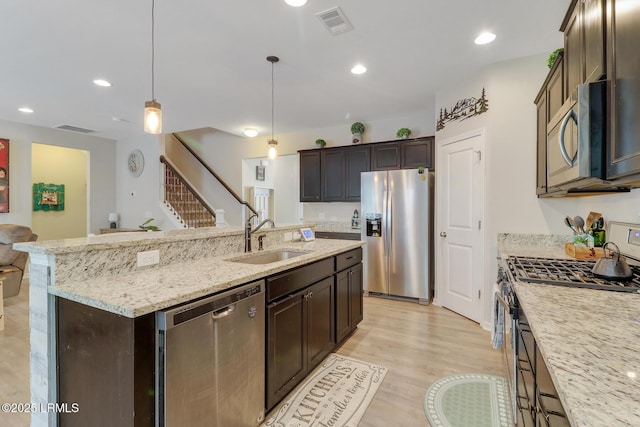 13 Hager Rd, Bluffton, SC 29910 - kitchen featuring dark brown cabinetry, visible vents, a sink, stainless steel appliances, and a center island with sink