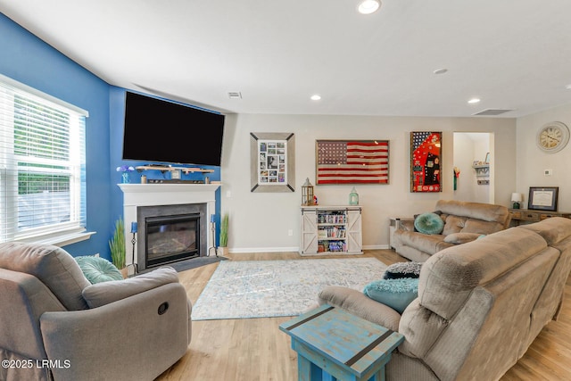 13 Hager Rd, Bluffton, SC 29910 - living area with visible vents, baseboards, recessed lighting, wood finished floors, and a fireplace with flush hearth