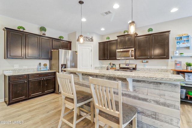 13 Hager Rd, Bluffton, SC 29910 - kitchen with light wood-type flooring, appliances with stainless steel finishes, visible vents, and dark brown cabinetry