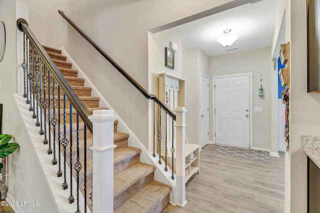 13 Hager Rd, Bluffton, SC 29910 - entrance foyer featuring light wood finished floors, baseboards, visible vents, and stairway
