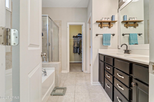 13 Hager Rd, Bluffton, SC 29910 - full bath featuring vanity, a spacious closet, tile patterned flooring, a shower stall, and a garden tub