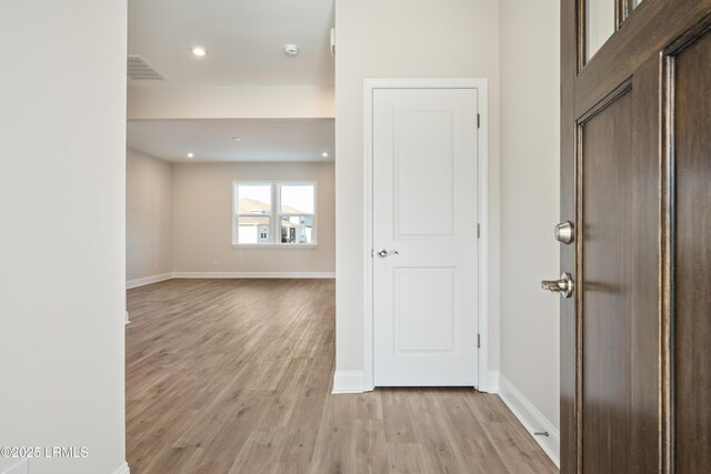 dining area with crown molding, a notable chandelier, and light wood-type flooring