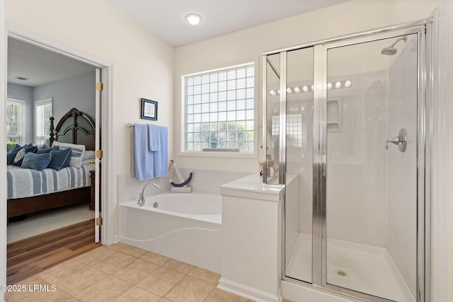 32 Aspen Hall Rd, Bluffton, SC 29910 - ensuite bathroom featuring a bath, a stall shower, plenty of natural light, and connected bathroom