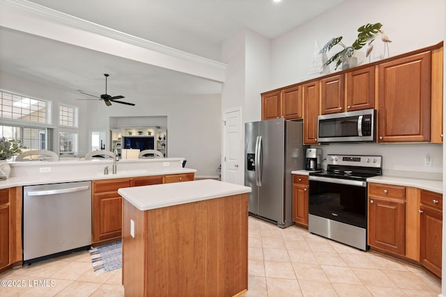 32 Aspen Hall Rd, Bluffton, SC 29910 - kitchen with stainless steel appliances, light countertops, a ceiling fan, light tile patterned flooring, and a center island