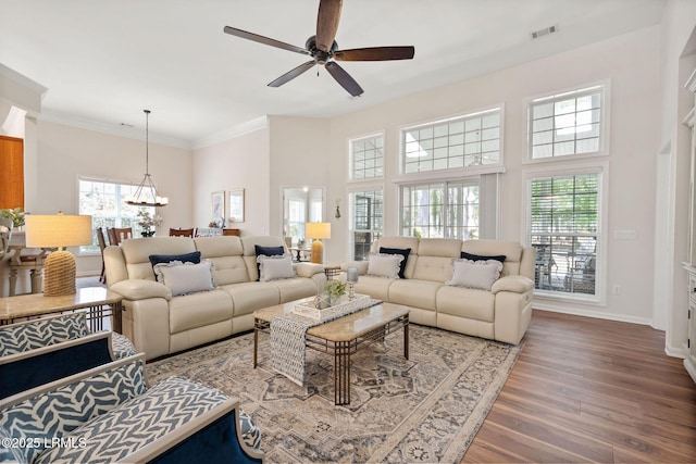 32 Aspen Hall Rd, Bluffton, SC 29910 - living room featuring ceiling fan with notable chandelier, plenty of natural light, wood finished floors, and visible vents