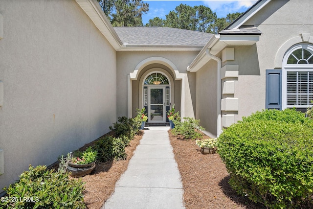 32 Aspen Hall Rd, Bluffton, SC 29910 - view of exterior entry with a shingled roof and stucco siding