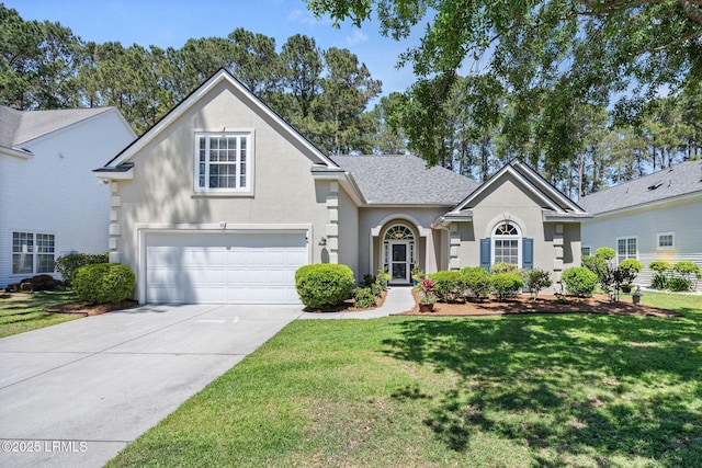 32 Aspen Hall Rd, Bluffton, SC 29910 - traditional-style house with stucco siding, an attached garage, concrete driveway, and a front yard